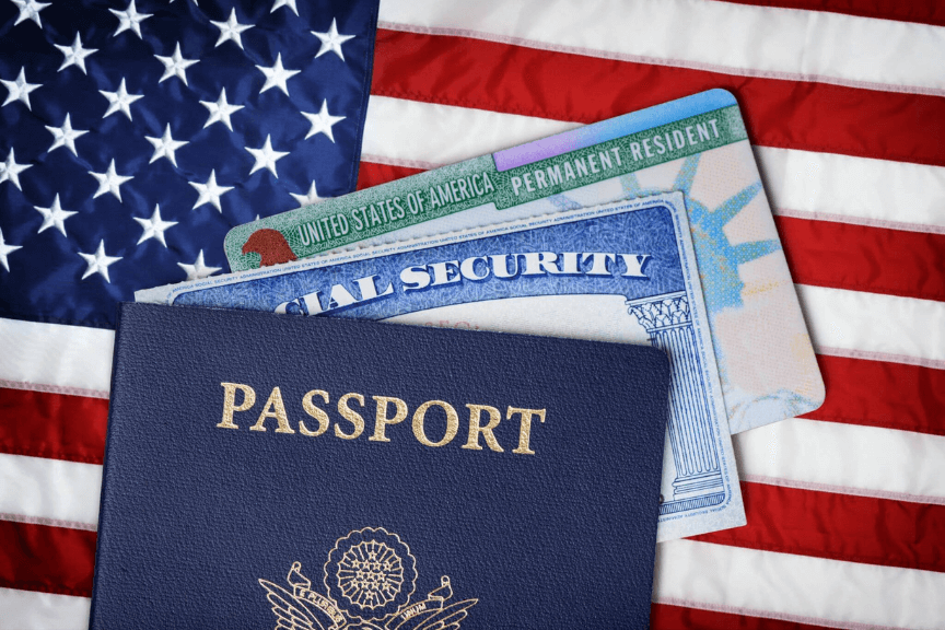 United States flag with an American passport, permanent residency, and Social Security card.