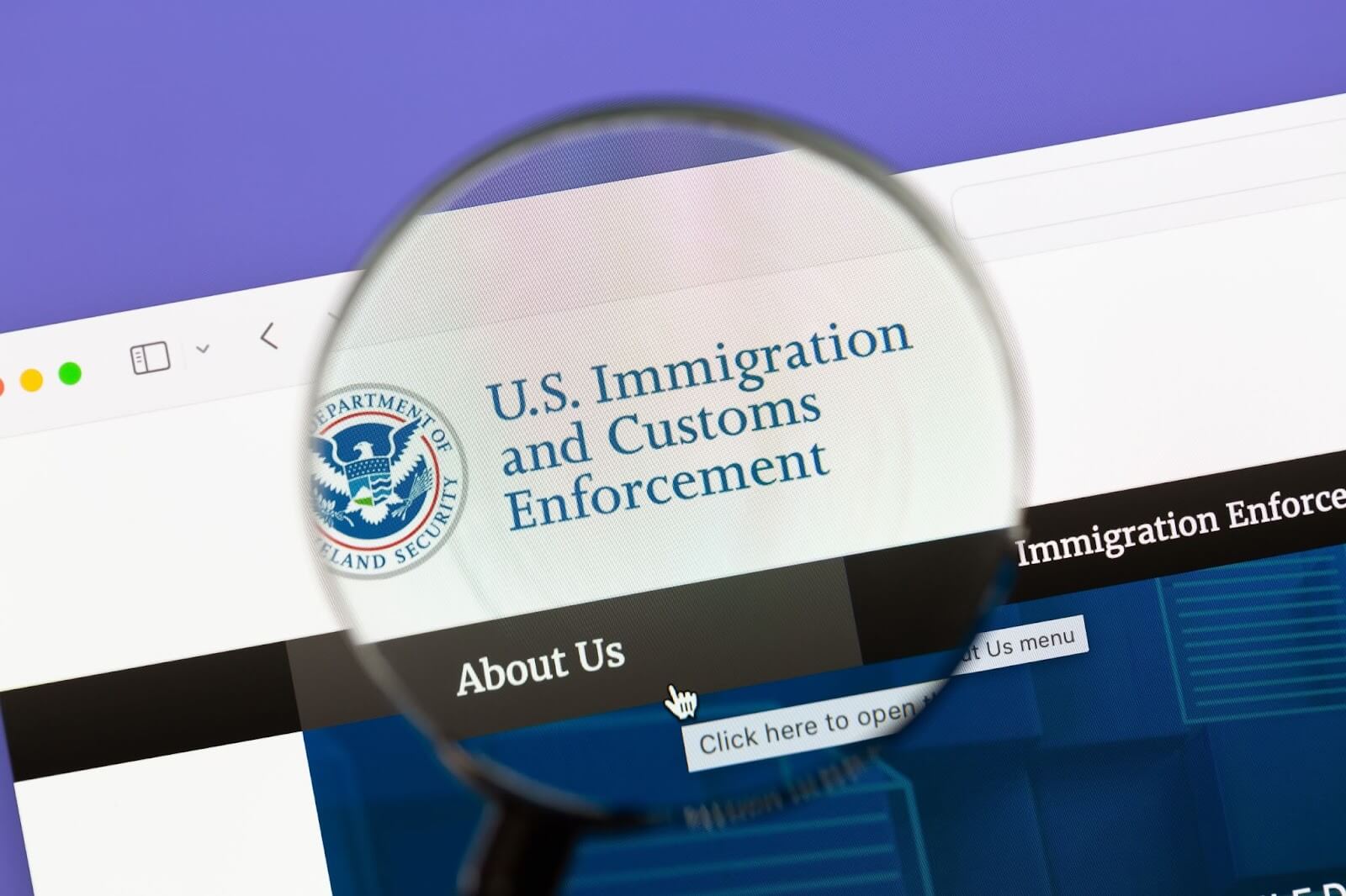 ICE website under a magnifying glass.