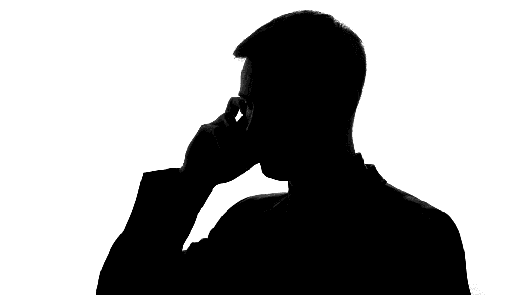 Silhouette of a man talking by cellphone