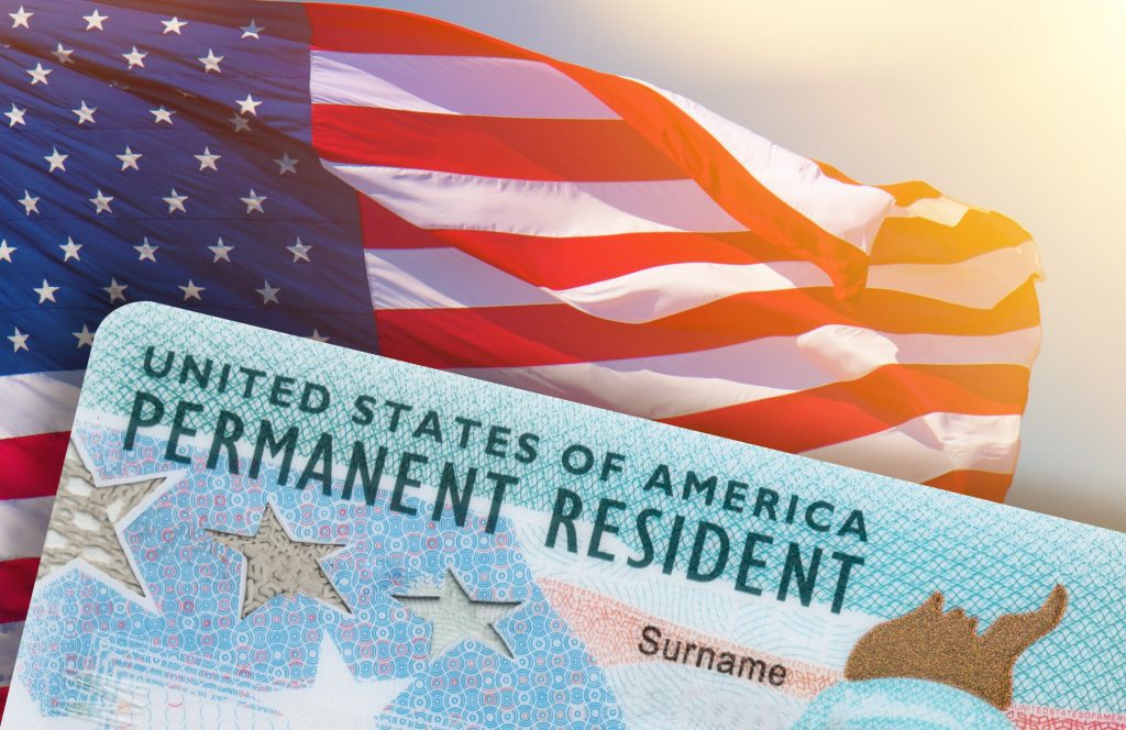 US permanent resident card with US flag on the background
