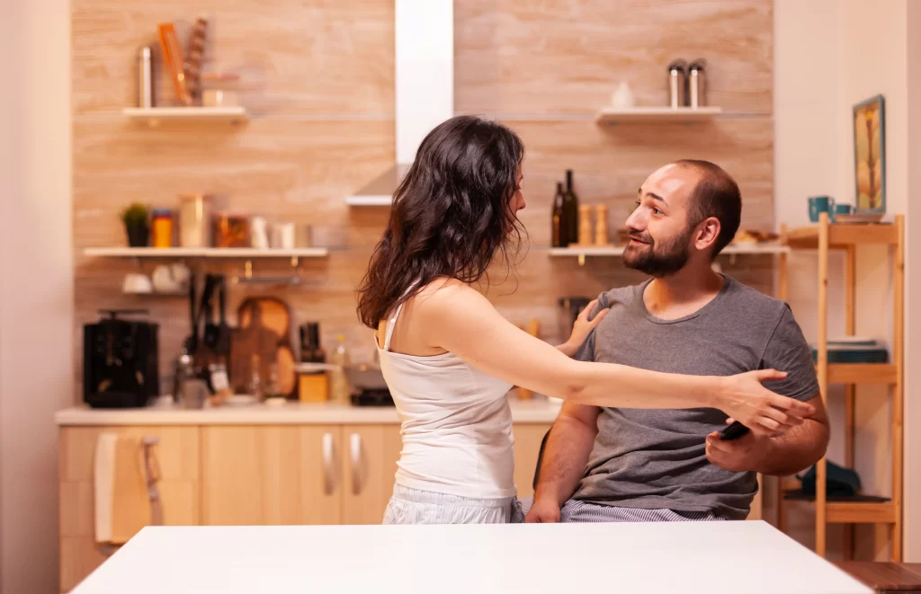 Woman trying to take away a cellphone from her husband