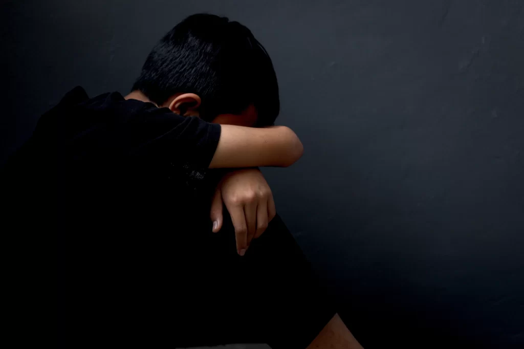 Side view of depressed and lonely boy sitting alon 2023 11 27 05 25 20