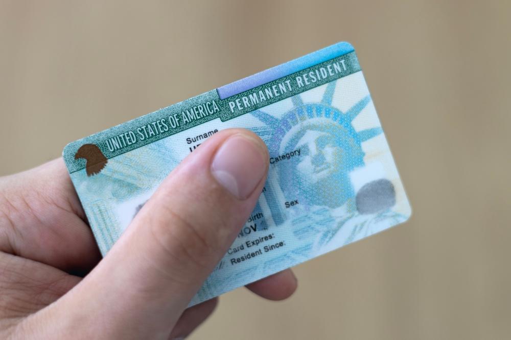 An immigrant holds a Green Card, showing his permanent residency in the United States. Does a T visa lead to a Green Card?