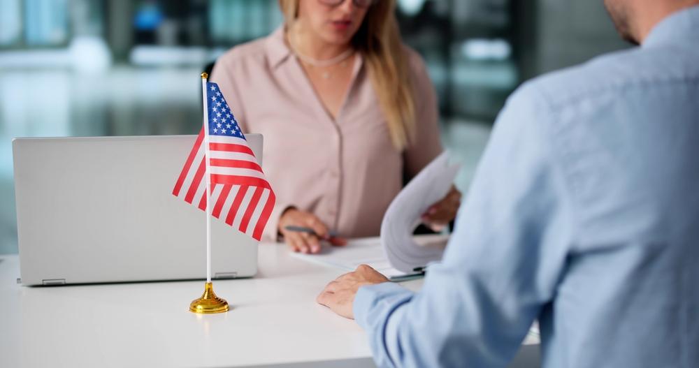 A person consulting an immigration lawyer. Learn about what temporary protected status is.